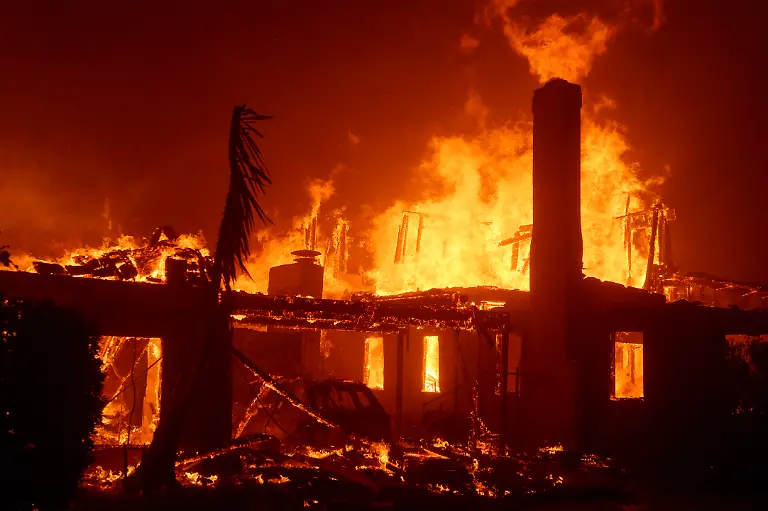 LOS-ANGELES-CALIFORNIA-JANUARY-7-Flames-from-the-Palisades-Fire-burn-a-home-on-January-7-2025-in-the-Pacific-Palisades-neighborhood-of-Los-Angeles-California