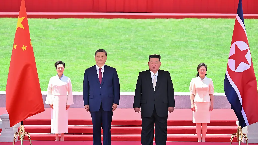 260608-PYONGYANG-June-8-2026-Xi-Jinping-general-secretary-of-the-Communist-Party-of-China-Central-Committee-and-Chinese-president-and-Kim-Jong-Un-general-secretary-of-the-Workers-Party-of-Korea-and-president-of-the-State-Affairs-of-the-Democratic-People-s-Republic-of-Korea-DPRK-watch-a-march-past-in-Pyongyang-the-DPRK-June-8-2026-Kim-held-a-grand-welcome-ceremony-for-Xi-at-Kim-Il-Sung-Square-in-Pyongyang
