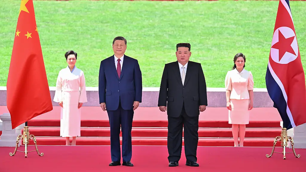 260608-PYONGYANG-June-8-2026-Xi-Jinping-general-secretary-of-the-Communist-Party-of-China-Central-Committee-and-Chinese-president-and-Kim-Jong-Un-general-secretary-of-the-Workers-Party-of-Korea-and-president-of-the-State-Affairs-of-the-Democratic-People-s-Republic-of-Korea-DPRK-watch-a-march-past-in-Pyongyang-the-DPRK-June-8-2026-Kim-held-a-grand-welcome-ceremony-for-Xi-at-Kim-Il-Sung-Square-in-Pyongyang