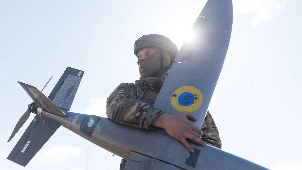 KHARKIV-REGION-UKRAINE-APRIL-7-A-portrait-of-a-soldier-from-the-Taifun-unmanned-aerial-vehicle-unit-holding-a-new-model-Marsianin-attack-drone-on-April-7-2026-in-Kharkiv-region-Ukraine-After-years-of-developing-systems-and-know-how-to-fend-off-Russia-s-drone-attacks-Ukraine-is-now-offering-its-hard-won-expertise-and-counter-drone-technology-to-other-countries-In-recent-weeks-Ukrainian-President-Volodymyr-Zelensky-has-been-visiting-Gulf-states-who-are-confronting-a-wave-of-relatively-cheap-kamikaze-drones-launched-by-Iran-as-it-lashes-out-neighboring-countries-after-the-joint-U-S-Israeli-attack