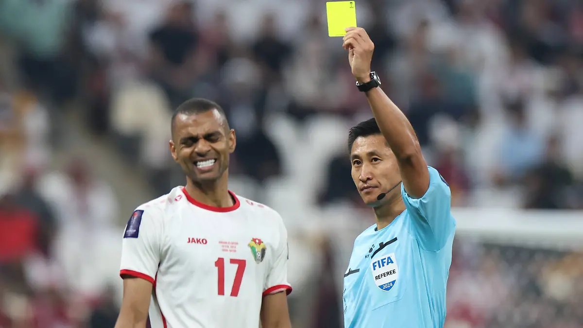 240211-LUSAIL-Feb-11-2024-Referee-Ma-Ning-R-shows-yellow-card-to-Jordan-s-Salem-Al-Ajalin-during-the-final-match-between-Qatar-and-Jordan-of-AFC-Asian-Cup-at-Lusail-Stadium-in-Lusail-Qatar-on-Feb-10-2024