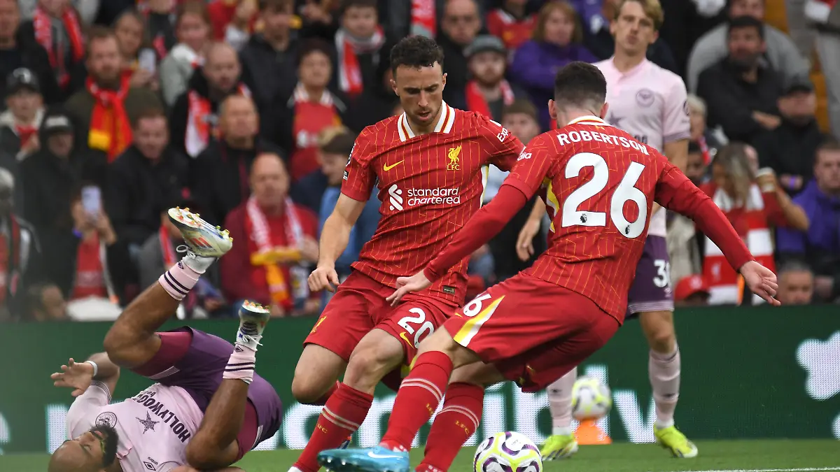 Liverpool-s-Andrew-Robertson-right-Liverpool-s-Diogo-Jota-centre-challenges-for-the-ball-with-Brentford-s-Bryan-Mbeumo-during-the-English-Premier-League-soccer-match-between-Liverpool-and-Brentford-at-Anfield-Stadium-Liverpool-England-Sunday-Aug-25-2024