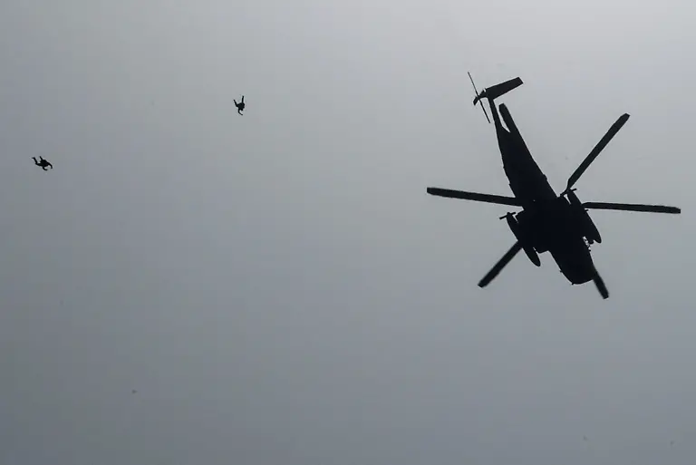 Members-of-the-German-Armed-Forces-jump-out-of-a-helicopter-to-descend-on-parachutes-during-the-International-Aerospace-Exhibition-ILA-on-the-opening-day-at-Schoenefeld-Airport-in-Berlin-Germany-June-10-2026