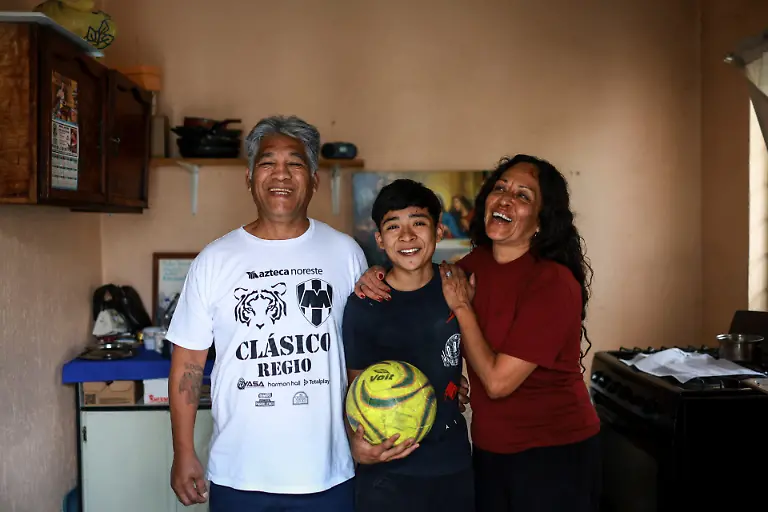 Humberto-Guadalupe-14-nicknamed-Messi-who-dreams-of-becoming-a-professional-soccer-player-poses-for-a-portrait-with-his-grandfather-Guadalupe-Mendonza-Guerrero-62-and-his-grandmother-Maria-del-Carmen-Gutierrez-Rodriguez-56-at-their-house-at-Cerro-de-la-Campana-in-Monterrey-Mexico-March-28-2026-REUTERS-Raquel-Cunha-SEARCH-CUNHA-MEXICO-SOCCER-FOR-THIS-STORY-SEARCH-WIDER-IMAGE-FOR-ALL-STORIES