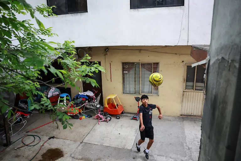Humberto-Guadalupe-14-nicknamed-Messi-who-dreams-of-becoming-a-professional-soccer-player-plays-football-in-the-backyard-of-his-house-in-Cerro-de-la-Campana-Monterrey-Mexico-March-28-2026-REUTERS-Raquel-Cunha-SEARCH-CUNHA-MEXICO-SOCCER-FOR-THIS-STORY-SEARCH-WIDER-IMAGE-FOR-ALL-STORIES