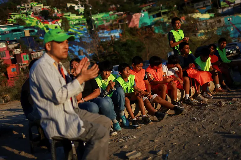 Children-from-communities-near-Cerro-de-la-Campana-listen-to-the-word-of-God-before-taking-part-in-a-soccer-match-in-Monterrey-Mexico-March-24-2026-REUTERS-Raquel-Cunha-SEARCH-CUNHA-MEXICO-SOCCER-FOR-THIS-STORY-SEARCH-WIDER-IMAGE-FOR-ALL-STORIES