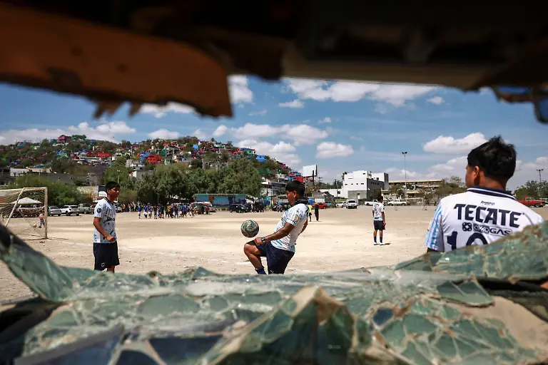 Pandilleros-team-members-are-seen-warming-up-through-a-broken-car-window-ahead-of-the-Cerro-de-la-Campana-llanero-soccer-championship-semifinal-against-Bandoleros-at-Los-Pinos-football-pitch-in-Monterrey-Mexico-March-29-2026-REUTERS-Raquel-Cunha-SEARCH-CUNHA-MEXICO-SOCCER-FOR-THIS-STORY-SEARCH-WIDER-IMAGE-FOR-ALL-STORIES