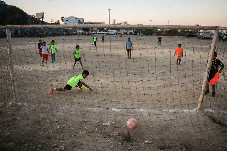 Children-from-communities-near-Cerro-de-la-Campana-take-part-in-a-soccer-match-that-begins-with-listening-to-the-word-of-God-followed-by-snacks-organized-by-evangelists-and-brothers-Rene-Cardona-and-Andres-Cardona-in-Monterrey-Mexico-March-24-2026-REUTERS-Raquel-Cunha-SEARCH-CUNHA-MEXICO-SOCCER-FOR-THIS-STORY-SEARCH-WIDER-IMAGE-FOR-ALL-STORIES