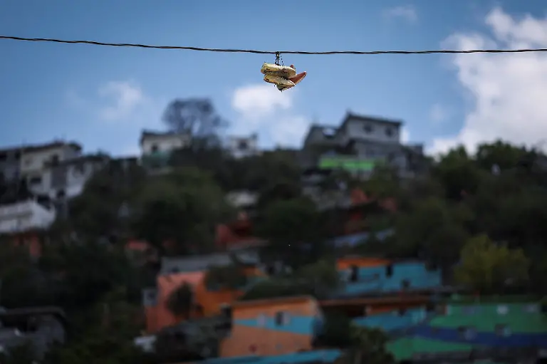 Football-boots-hang-from-an-electricity-wire-with-Cerro-de-la-Campana-in-the-background-at-Los-Pinos-football-pitch-in-Monterrey-Mexico-March-29-2026-REUTERS-Raquel-Cunha-SEARCH-CUNHA-MEXICO-SOCCER-FOR-THIS-STORY-SEARCH-WIDER-IMAGE-FOR-ALL-STORIES