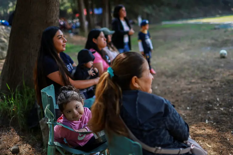 Aitana-Michelle-Hernandez-Blas-2-years-4-months-and-her-mother-sit-as-they-watch-Aitana-s-father-play-at-the-Cancha-de-los-Dioses-Field-of-the-Gods-a-soccer-field-inside-the-crater-of-the-dormant-Teoca-volcano-in-the-mountains-between-Xochimilco-and-Milpa-Alta-in-Mexico-City-Mexico-May-17-2026-The-community-flattened-the-crater-more-than-60-years-ago-to-build-the-field-where-local-amateur-teams-play-matches-every-Sunday-REUTERS-Raquel-Cunha-SEARCH-CUNHA-MEXICO-SOCCER-FOR-THIS-STORY-SEARCH-WIDER-IMAGE-FOR-ALL-STORIES
