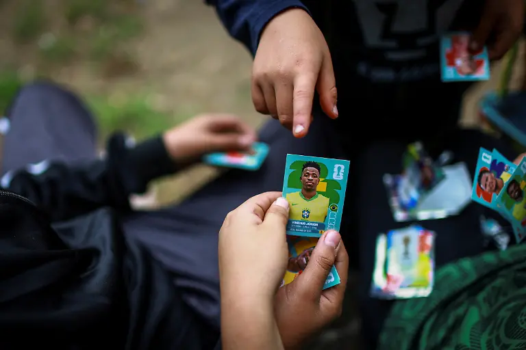 Kids-trade-a-sticker-of-Brazillian-player-Vinicius-Junior-from-the-World-Cup-album-at-the-Cancha-de-los-Dioses-Field-of-the-Gods-a-soccer-field-inside-the-crater-of-the-dormant-Teoca-volcano-in-the-mountains-between-Xochimilco-and-Milpa-Alta-in-Mexico-City-Mexico-May-24-2026-The-community-flattened-the-crater-more-than-60-years-ago-to-build-the-field-where-local-amateur-teams-play-matches-every-Sunday-REUTERS-Raquel-Cunha-SEARCH-CUNHA-MEXICO-SOCCER-FOR-THIS-STORY-SEARCH-WIDER-IMAGE-FOR-ALL-STORIES
