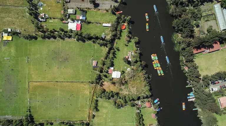 A-drone-view-shows-locals-playing-football-at-pitches-as-people-ride-boats-and-trajineras-in-the-Xochimilco-ecological-zone-composed-of-water-channels-and-chinampas-or-so-called-floating-gardens-a-reminder-of-traditional-pre-Hispanic-land-use-in-Mexico-City-Mexico-March-1-2026-REUTERS-Raquel-Cunha-SEARCH-CUNHA-MEXICO-SOCCER-FOR-THIS-STORY-SEARCH-WIDER-IMAGE-FOR-ALL-STORIES