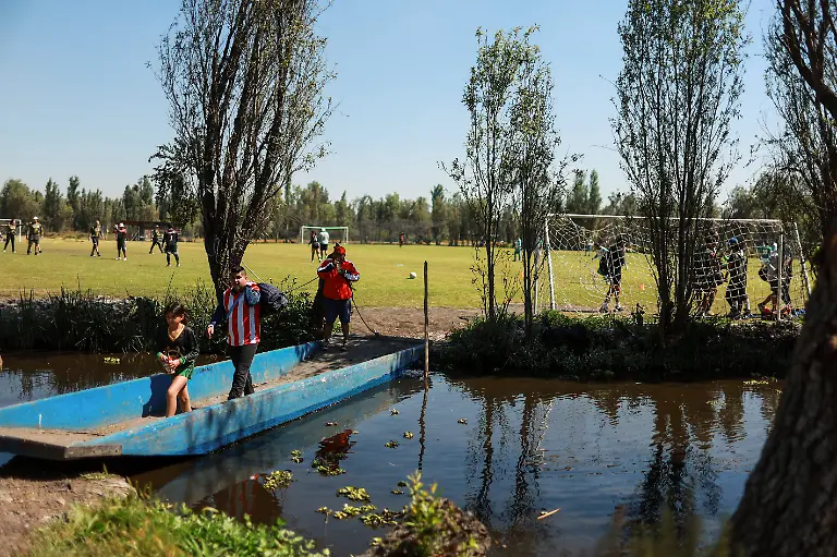 People-ride-a-trajinera-towards-football-fields-to-take-part-in-amateur-league-matches-in-the-protected-Xochimilco-area-in-southern-Mexico-City-Mexico-March-1-2026-The-UNESCO-World-Heritage-site-known-for-its-canals-and-chinampas-or-so-called-floating-gardens-remains-a-social-hub-where-residents-gather-for-weekend-football-matches-REUTERS-Raquel-Cunha-SEARCH-CUNHA-MEXICO-SOCCER-FOR-THIS-STORY-SEARCH-WIDER-IMAGE-FOR-ALL-STORIES