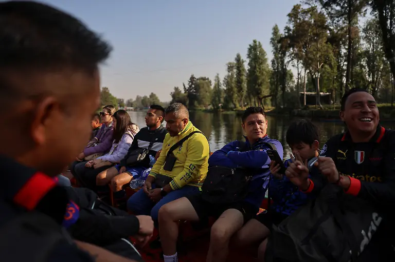 People-ride-a-trajinera-towards-football-fields-to-take-part-in-amateur-league-matches-in-the-protected-Xochimilco-area-in-southern-Mexico-City-Mexico-March-8-2026-The-UNESCO-World-Heritage-site-known-for-its-canals-and-chinampas-or-so-called-floating-gardens-remains-a-social-hub-where-residents-gather-for-weekend-football-matches-REUTERS-Raquel-Cunha-SEARCH-CUNHA-MEXICO-SOCCER-FOR-THIS-STORY-SEARCH-WIDER-IMAGE-FOR-ALL-STORIES