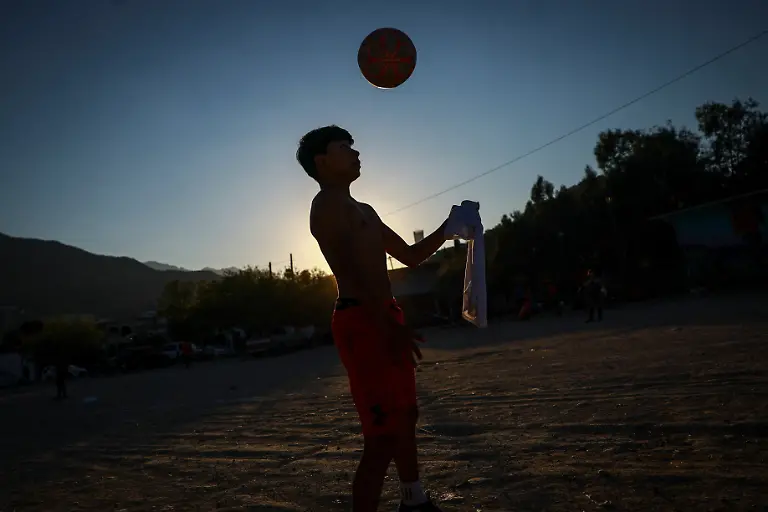 Humberto-Guadalupe-14-nicknamed-Messi-who-dreams-of-becoming-a-professional-soccer-player-plays-during-a-soccer-match-that-begins-with-listening-to-the-word-of-God-followed-by-snacks-organized-by-evangelists-and-brothers-Rene-and-Andres-Cardona-in-Monterrey-Mexico-March-24-2026-REUTERS-Raquel-Cunha-SEARCH-CUNHA-MEXICO-SOCCER-FOR-THIS-STORY-SEARCH-WIDER-IMAGE-FOR-ALL-STORIES
