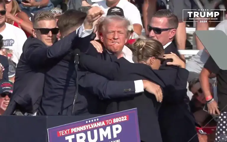 BUTLER-PENNSYLVANIA-UNITED-STATES-JULY-13-EDITORIAL-USE-ONLY-MANDATORY-CREDIT-TRUMP-CAMPAIGN-OFFICE-HANDOUT-NO-MARKETING-NO-ADVERTISING-CAMPAIGNS-DISTRIBUTED-AS-A-SERVICE-TO-CLIENTS-A-screen-grab-captured-from-a-video-shows-Republican-presidential-candidate-former-President-Donald-Trump-appears-to-be-injured-after-gunshots-were-reported-as-he-is-rushed-offstage-during-a-rally-on-July-13-2024-in-Butler-Pennsylvania-Trump-was-seen-bloodied-on-his-right-ear-as-he-was-being-evacuated-from-the-stage-according-to-social-media-footage