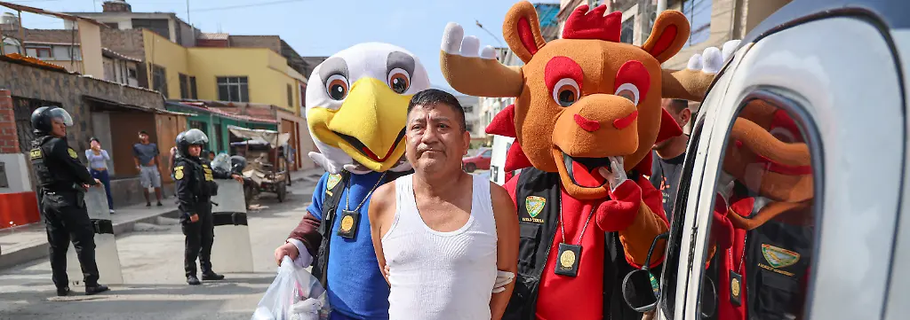 This-handout-picture-released-by-Peru-s-National-Police-shows-officers-from-the-Terna-Unit-fancy-dressed-as-mascots-of-the-FIFA-World-Cup-arresting-a-man-during-an-undercover-operation-under-a-search-and-seizure-warrant-for-the-alleged-crime-of-small-scale-drug-trafficking-in-Lima-on-June-10-2026