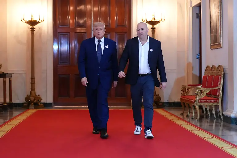 President-Donald-Trump-walks-with-UFC-president-and-CEO-Dana-White-through-the-Cross-Hall-of-the-White-House-before-attending-the-UFC-Freedom-250-fights-on-the-South-Lawn-of-the-White-House-Sunday-June-14-2026-in-Washington