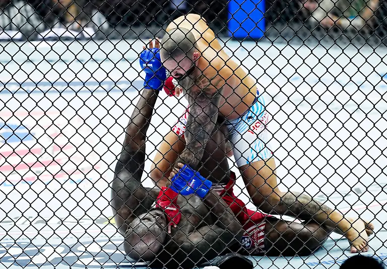 UFC-Heavyweight-Josh-Hokit-takes-Derrick-Lewis-to-the-mat-during-the-Freedom-250-UFC-fight-card-on-the-South-Lawn-of-the-White-House-in-Washington-DC-on-Sunday-June-14-2026-The-mixed-martial-arts-bouts-are-being-held-as-part-of-President-Trump-s-80th-birthday-weekend-activities