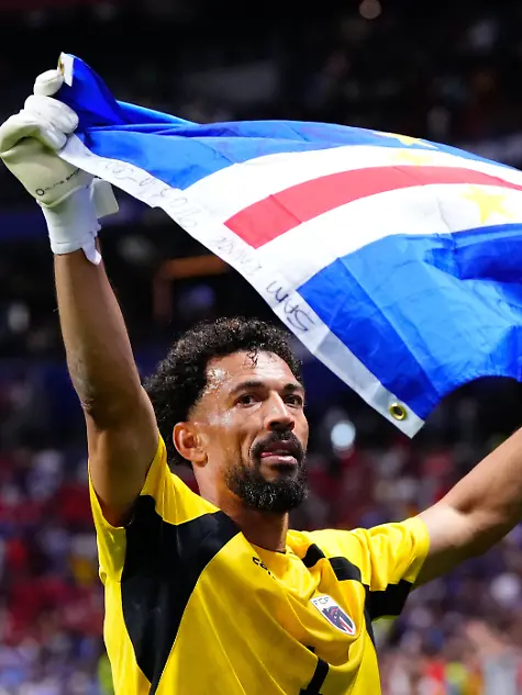 Vozinha-of-Cabo-Verde-celebrates-with-the-flag-of-Cabo-Verde-during-the-FIFA-World-Cup-2026-Group-H-match-between-Spain-and-Cabo-Verde-at-Atlanta-Stadium-on-June-15-2026-in-Atlanta-United-States