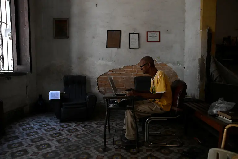 Sagrado-Armando-Garcia-85-a-retired-government-bureaucrat-writing-a-book-on-a-borrowed-laptop-types-at-home-where-he-lives-alone-in-Havana-Cuba-April-28-2026-Cuba-has-struggled-for-years-under-U-S-sanctions-to-provide-basic-services-Garcia-said-he-collapsed-in-his-home-and-his-son-could-not-get-him-to-the-hospital-because-there-was-no-fuel-for-the-family-car-They-are-leaving-us-to-our-fate-he-said-REUTERS-Norlys-Perez-SEARCH-NORLYS-CUBA-ELDERLY-FOR-THIS-STORY-SEARCH-WIDER-IMAGE-FOR-ALL-STORIES
