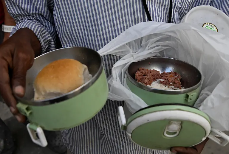 A-man-holds-a-meal-prepared-at-a-Sistema-de-Atencion-a-la-Familia-SAF-dining-hall-that-provides-rations-to-the-people-in-need-in-Havana-Cuba-March-10-2026-Pensions-in-Cuba-have-shrunk-to-the-equivalent-of-7-a-month-on-the-black-market-exchange-as-the-peso-has-lost-about-a-third-of-its-value-against-the-dollar-since-the-start-of-the-blockade-REUTERS-Norlys-Perez-SEARCH-NORLYS-CUBA-ELDERLY-FOR-THIS-STORY-SEARCH-WIDER-IMAGE-FOR-ALL-STORIES