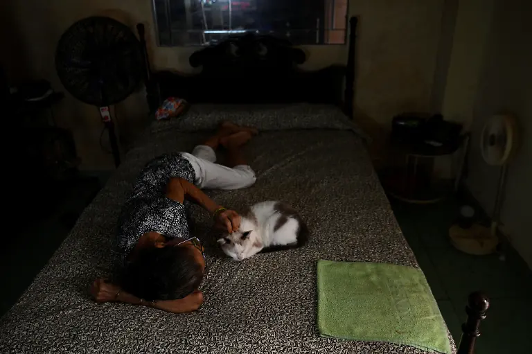 Regla-Rodriguez-70-a-widow-who-lives-off-her-work-as-a-seamstress-lies-next-to-her-cat-at-home-in-Havana-Cuba-March-6-2026-Cuba-the-fastest-aging-nation-in-Latin-America-and-the-Caribbean-has-struggled-for-years-under-U-S-sanctions-to-provide-basic-services-with-seniors-now-facing-harsher-conditions-after-a-Trump-administration-move-to-cut-off-the-island-s-fuel-supply-REUTERS-Norlys-Perez-SEARCH-NORLYS-CUBA-ELDERLY-FOR-THIS-STORY-SEARCH-WIDER-IMAGE-FOR-ALL-STORIES