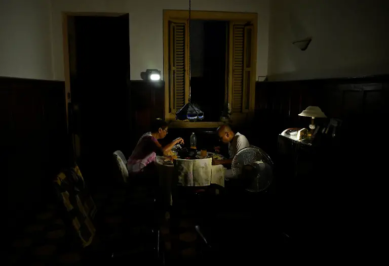 Mayra-Madariaga-72-and-Renato-Lombard-74-a-pensioned-couple-whose-three-children-live-in-the-U-S-eat-dinner-at-home-by-the-light-of-flashlights-during-a-blackout-in-Havana-Cuba-September-2-2025-Cuba-has-appealed-to-the-United-Nations-World-Food-Programme-for-support-to-maintain-meals-for-vulnerable-groups-This-is-a-very-high-risk-population-right-now-REUTERS-Norlys-Perez-SEARCH-NORLYS-CUBA-ELDERLY-FOR-THIS-STORY-SEARCH-WIDER-IMAGE-FOR-ALL-STORIES