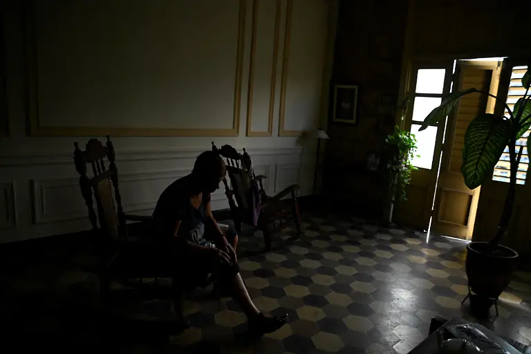 Mayra-Madariaga-72-puts-on-a-knee-brace-in-the-living-room-of-her-home-during-a-blackout-in-Havana-Cuba-September-24-2025-The-number-of-doctors-in-Cuba-has-fallen-30-since-2019-while-70-of-essential-medicines-are-scarce-or-unavailable-Surgery-waiting-lists-are-expected-to-reach-160-000-patients-this-year-REUTERS-Norlys-Perez-SEARCH-NORLYS-CUBA-ELDERLY-FOR-THIS-STORY-SEARCH-WIDER-IMAGE-FOR-ALL-STORIES