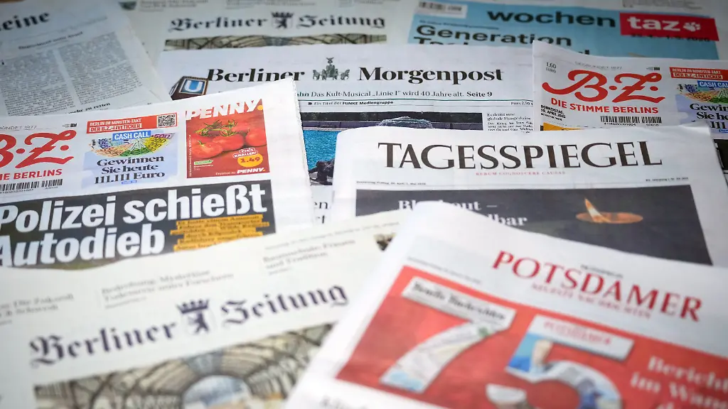 Lokalzeitungen-und-andere-gedruckte-Zeitungen-liegen-nebeneinander-auf-einem-Tisch-Aus-Anlass-des-Tages-des-Lokaljournalismus-05-05-wollen-Zeitungsleser-mit-Bundeskanzler-Merz-ueber-Themen-reden-die-die-Menschen-vor-Ort-bewegen