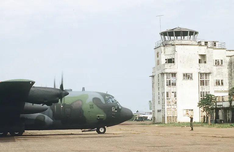 RECORD-DATE-NOT-STATED-An-Air-National-Guard-C-130-Hercules-is-marshaled-into-position-on-the-flight-line-ramp-in-front-of-the-Entebbe-Airport-control-tower-building-The-airport-was-used-as-a-staging-distribution-point-for-relief-supplies-destined-in-support-of-the-Rwandan-humanitarian-relief-effort