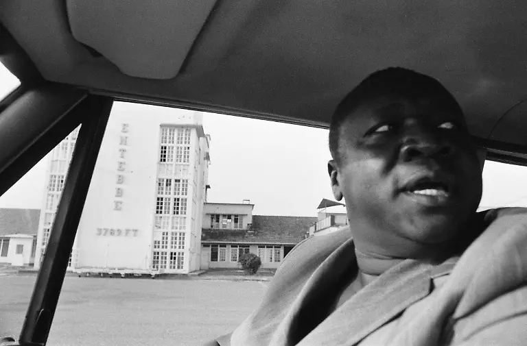 President-Idi-Amin-at-the-wheel-of-his-Range-Rover-at-Entebbe-Airport-near-Kampala-Uganda-In-the-background-is-the-terminal-building-where-passangers-and-crew-of-a-hijacked-Air-France-flight-were-kept-hostage-the-previous-year-27th-February-1977