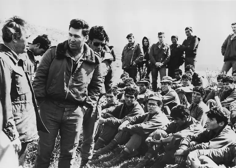 Israeli-Defence-Minister-Shimon-Peres-left-and-Major-Dan-Shomron-second-from-left-with-Israeli-paratroops-after-the-completion-of-Operation-Entebbe-July-1976-The-raid-commanded-by-Shomron-took-place-on-3rd-July-1976-and-resulted-in-the-rescue-by-Israeli-special-forces-of-100-hostages-held-at-Entebbe-Airport-in-Uganda-by-members-of-the-Popular-Front-for-the-Liberation-of-Palestine