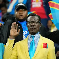 FILE-Michel-Nkuka-Mboladinga-a-DR-Congo-fan-impersonating-late-Congolese-leader-Patrice-Lumumba-strikes-a-pose-during-the-Africa-Cup-of-Nations-group-D-soccer-match-between-Botswana-and-DR-Congo-in-Rabat-Morocco-Tuesday-Dec-30-2025
