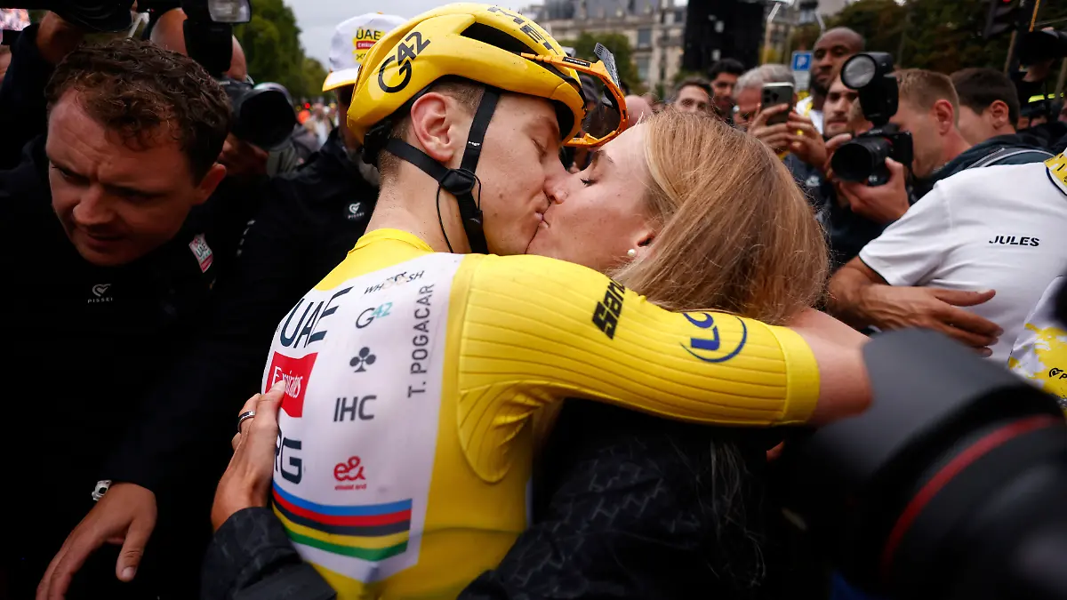 Slovenia-s-Tadej-Pogacar-the-Tour-de-France-winner-is-greeted-by-his-partner-Urska-Zigart-after-finishing-the-twenty-first-stage-of-the-Tour-de-France-cycling-race-over-132-3-kilometers-82-1-miles-with-start-in-Mantes-la-Ville-and-finish-on-the-Champs-Elysees-in-Paris-France-Sunday-July-27-2025