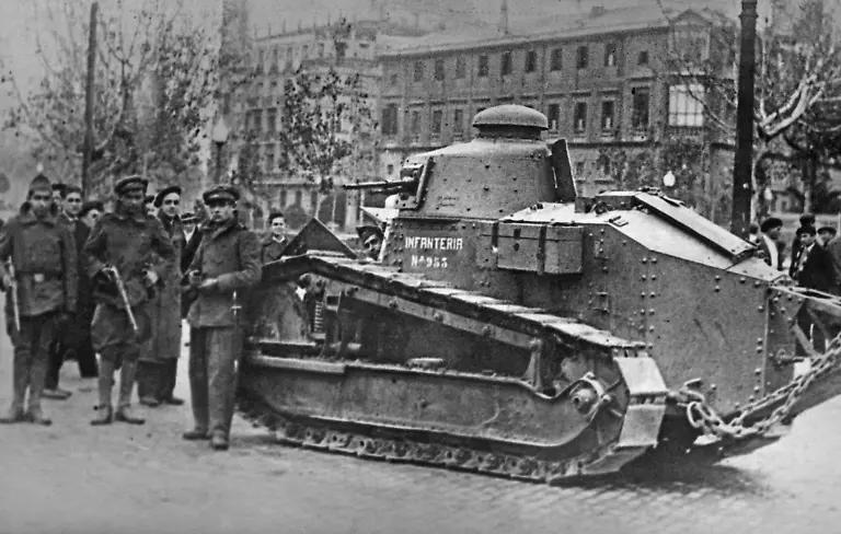 Eine-Gruppe-von-nationalspanischen-Anhaengern-links-in-uneinheitlichen-Uniformen-posiert-im-Zentrum-von-Saragossa-Aragon-Spanien-vor-einem-leichten-Panzer-bewaffnet-mit-einer-Maschinekanone-franzoesisches-Modell-Renault-FT17-der-spanischen-Infanterie-Im-Hintergrund-stehen-Passanten-Im-Juli-1936-versuchten-die-Republikaner-vergeblich-Saragossa-einzunehmen-Eine-weitere-Offensive-im-September-1937-scheiterte-Aufnahmedatum-01-01-1936-31-12