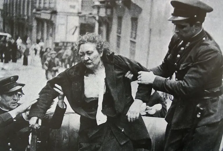 Spanish-woman-is-injured-and-helped-by-Assault-guards-in-Madrid-during-riots-in-the-1936-Election-Assault-Guards-enforced-security-on-election-day-many-freed-from-their-regular-posts-by-the-carabineros-Six-people-were-killed-during-the-elections-and-perhaps-another-30-injured