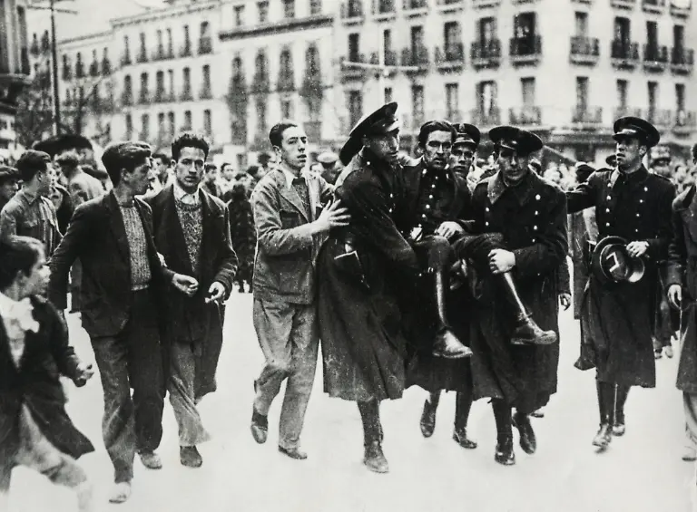 A-Guardia-de-Asalto-Assault-Guard-injured-during-a-street-clash-being-carried-from-the-field-by-his-comrades-1936-Barcelona-Spain-Spanish-Civil-War-20th-century