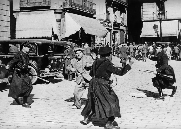 SPAIN-FEBRUARY-16-Demonstrators-being-arrested-by-the-police-during-election-day-February-16-1936-in-Barcelona-The-first-results-giving-the-victory-to-the-Republicans-set-off-demonstrations-and-public-meetings-The-demonstrators-demanded-the-liberation-of-prisoners-a-general-amnesty-and-that-the-current-government-step-down