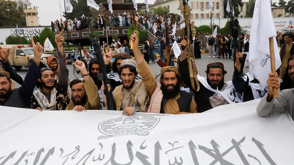 Taliban-fighters-hold-an-Islamic-Emirate-of-Afghanistan-flag-on-the-first-anniversary-of-the-fall-of-Kabul-on-a-street-in-Kabul-Afghanistan-August-15-2022