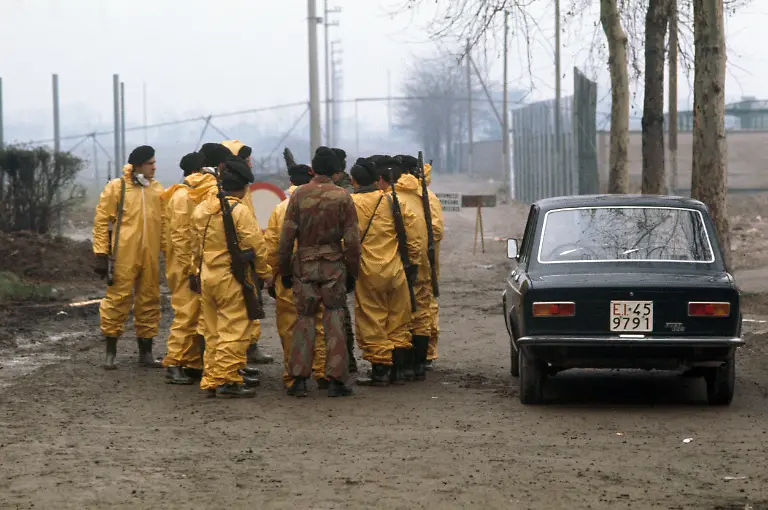 Soldiers-in-protective-gear-have-taken-over-security-tasks-after-the-chemical-accident-at-the-chemical-manufacturing-plant-Icmesa-near-Seveso-Italy-pictured-on-February-22-1977-On-July-10-1976-a-reactor-explosion-takes-place-at-Icmesa-an-affiliate-of-Givaudan-at-the-periphery-of-the-municipality-of-Meda-near-Milan-in-which-a-cloud-of-dioxin-is-released-The-wind-subsequently-spreads-the-poison-across-a-large-area-and-the-cloud-descends-over-the-neighboring-municipality-of-Seveso