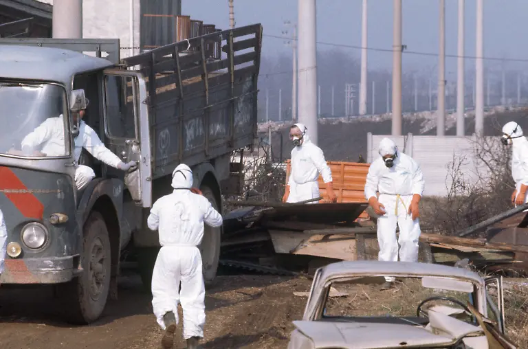 Even-one-year-after-the-chemical-accident-at-the-chemical-manufacturing-plant-Icmesa-near-Seveso-Italy-only-workers-in-protective-gear-are-allowed-to-stay-in-the-area-of-danger-zone-A-for-cleaning-and-decontamination-operations-pictured-on-July-7-1977-On-July-10-1976-a-reactor-explosion-takes-place-at-Icmesa-an-affiliate-of-Givaudan-at-the-periphery-of-the-municipality-of-Meda-near-Milan-in-which-a-cloud-of-dioxin-is-released-The-wind-subsequently-spreads-the-poison-across-a-large-area-and-the-cloud-descends-over-the-neighboring-municipality-of-Seveso