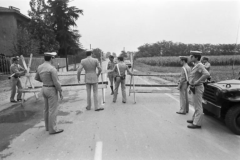 After-the-chemical-accident-at-the-chemical-manufacturing-plant-Icmesa-the-police-cordons-off-and-guards-the-entrance-to-danger-zone-A-near-Seveso-Italy-pictured-in-July-1976-On-July-10-1976-a-reactor-explosion-takes-place-at-Icmesa-an-affiliate-of-Givaudan-at-the-periphery-of-the-municipality-of-Meda-near-Milan-in-which-a-cloud-of-dioxin-is-released-The-wind-subsequently-spreads-the-poison-across-a-large-area-and-the-cloud-descends-over-the-neighboring-municipality-of-Seveso