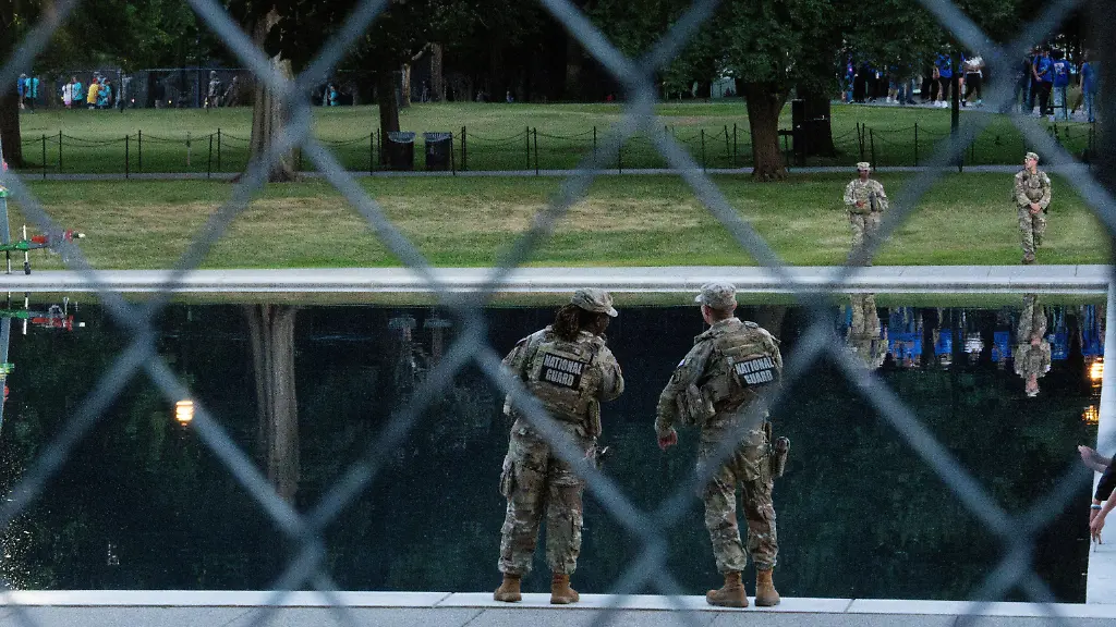 Members-of-the-National-Guard-stand-close-to-a-fence-near-the-Lincoln-Memorial-Reflecting-Pool-after-recent-renovations-following-a-directive-from-U-S-President-Donald-Trump-to-paint-it-blue-ahead-of-the-250th-anniversary-of-U-S-Independence-in-Washington-D-C-U-S-June-23-2026