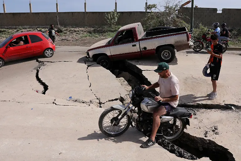 A-man-sits-on-a-bike-on-a-damaged-road-after-earthquakes-hit-the-country-in-La-Guaira-Venezuela-June-25-2026