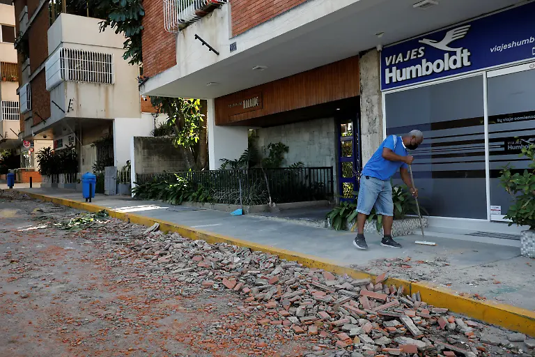A-man-cleans-debris-from-the-street-after-earthquakes-hit-the-country-in-Caracas-Venezuela-June-25-2026
