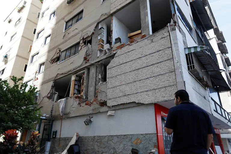 A-man-looks-at-a-building-damaged-by-earthquakes-that-hit-the-country-in-Caracas-Venezuela-June-25-2026