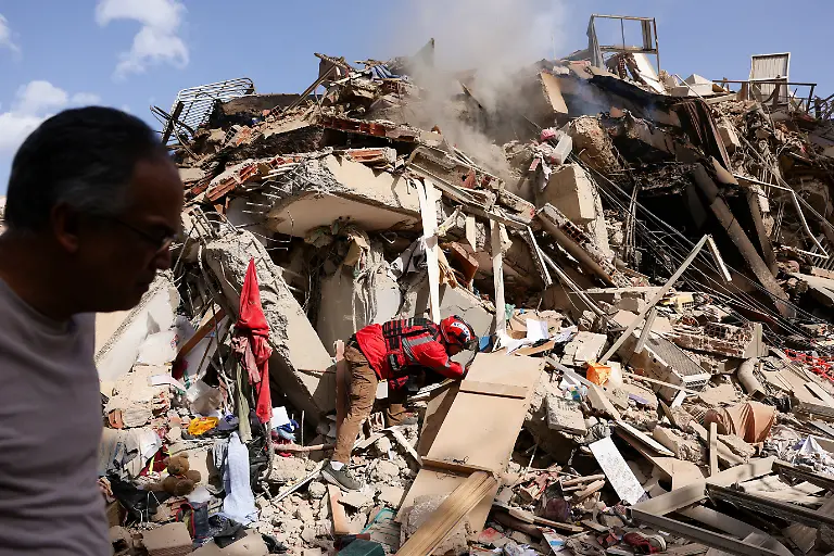 Juan-Carlos-Gomez-firefighter-from-Caracas-looks-for-his-sister-Katiuska-Hernandez-and-nephew-Brett-Roude-amid-the-rubble-of-a-building-after-earthquakes-hit-the-country-in-La-Guaira-Venezuela-June-25-2026