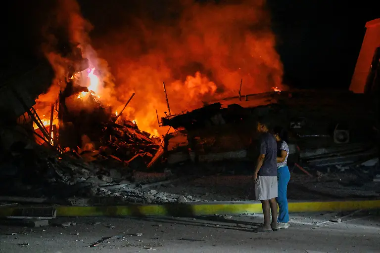 People-stand-near-destroyed-buildings-after-an-earthquake-in-La-Guaira-Venezuela-June-25-2026