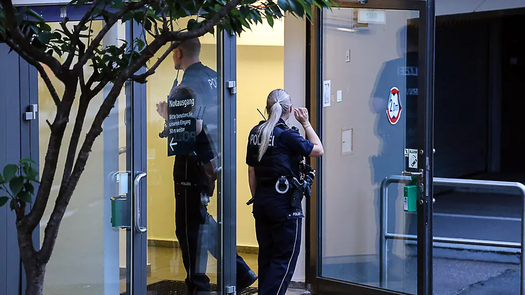 Einsatzkraefte-der-Polizei-stehen-am-Eingang-eines-Krankenhauses-im-Maerkischen-Kreis-Eine-unbekannte-Frau-hat-ein-Neugeborenes-aus-dem-Krankenhaus-mitgenommen-Der-sieben-Tage-alte-Saeugling-wurde-im-Nebenraum-eines-Parkhauses-gefunden-wie-die-Polizei-mitteilte